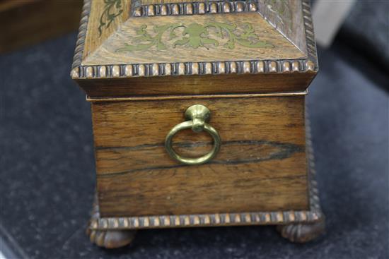 A Regency rosewood and brass inlaid sarcophagus shaped tea caddy, 13.75in.